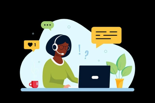 Illustration of a support agent responding to messages and questions on a laptop.