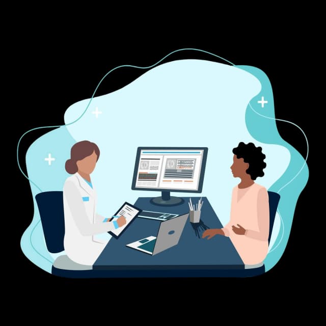 Doctor and patient reviewing medical data on a computer screen and tablet.