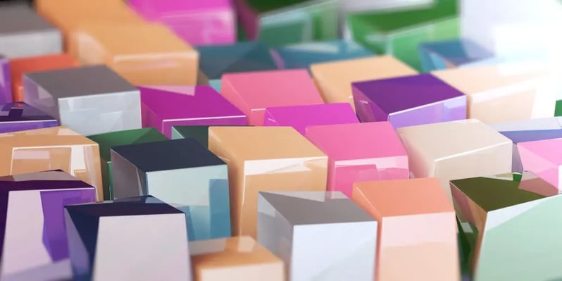 A close-up of a colorful array of three-dimensional blocks, creating a vibrant and abstract mosaic.